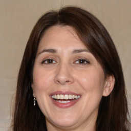 Joyful white adult female with long  brown hair and brown eyes