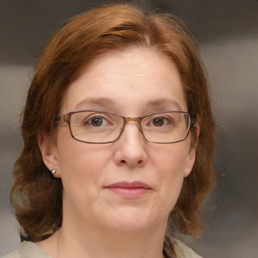 Joyful white adult female with medium  brown hair and blue eyes