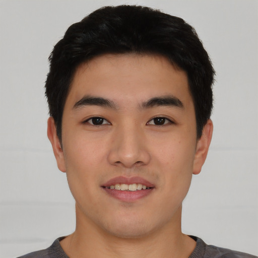 Joyful asian young-adult male with short  black hair and brown eyes