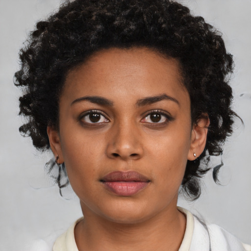 Neutral black young-adult female with medium  brown hair and brown eyes