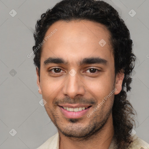 Joyful latino young-adult male with short  black hair and brown eyes