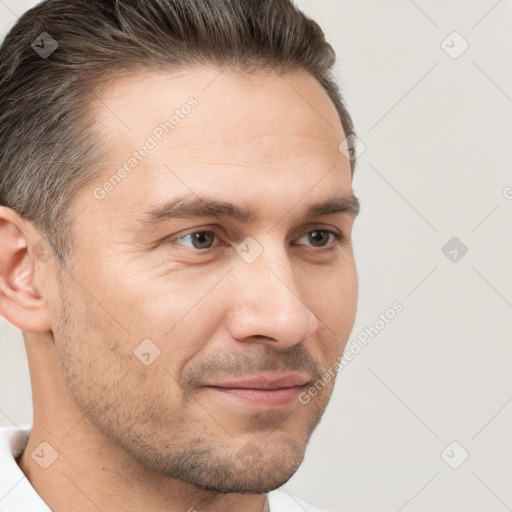 Joyful white adult male with short  brown hair and brown eyes