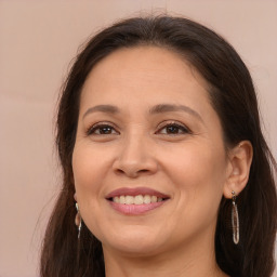 Joyful white adult female with long  brown hair and brown eyes