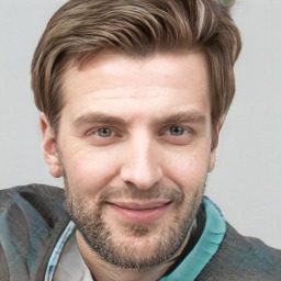 Joyful white young-adult male with short  brown hair and blue eyes