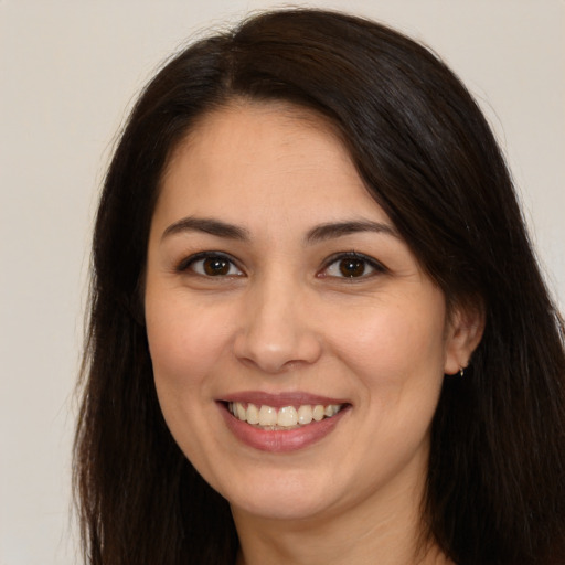 Joyful white young-adult female with long  brown hair and brown eyes