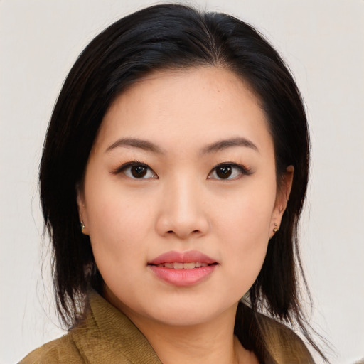 Joyful asian young-adult female with long  black hair and brown eyes