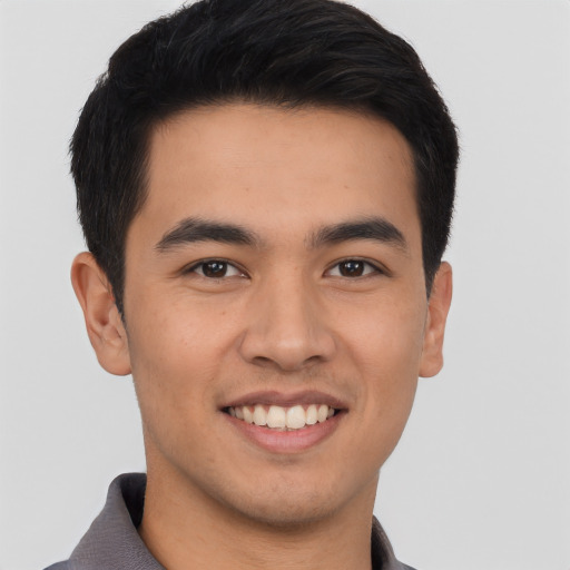 Joyful asian young-adult male with short  black hair and brown eyes