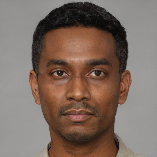 Neutral black young-adult male with short  black hair and brown eyes