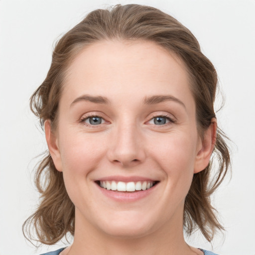 Joyful white young-adult female with medium  brown hair and blue eyes