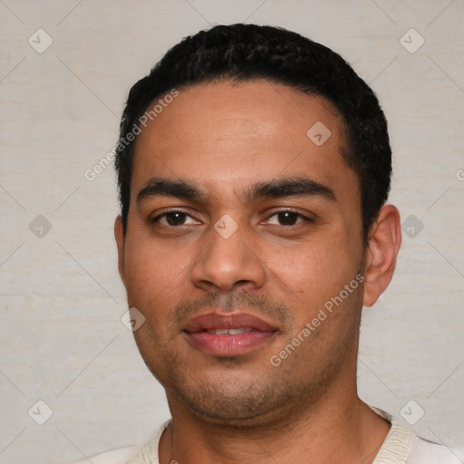 Joyful latino young-adult male with short  black hair and brown eyes