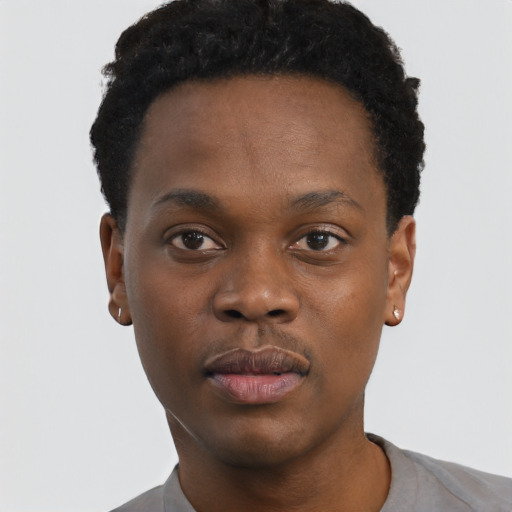 Joyful black young-adult male with short  black hair and brown eyes