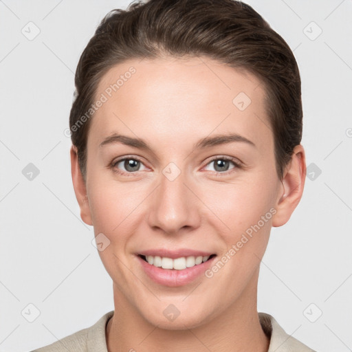 Joyful white young-adult female with short  brown hair and grey eyes