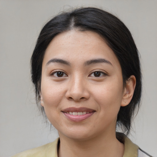 Joyful white young-adult female with medium  black hair and brown eyes