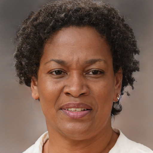 Joyful black adult female with short  brown hair and brown eyes