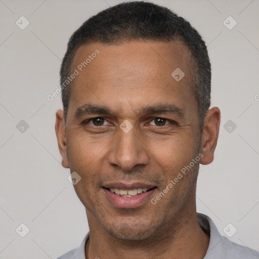 Joyful latino adult male with short  black hair and brown eyes