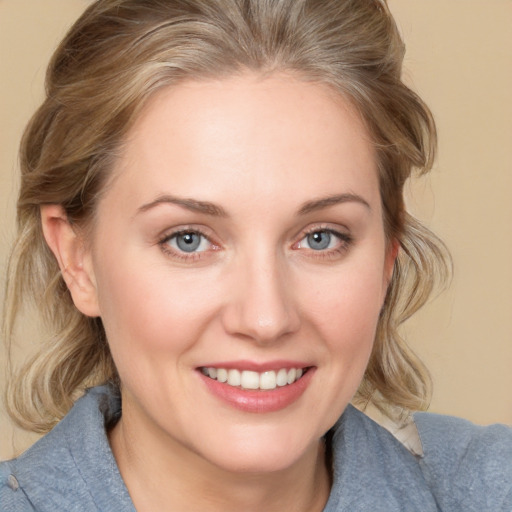 Joyful white young-adult female with medium  brown hair and blue eyes