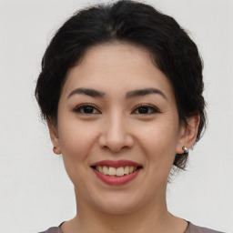 Joyful asian young-adult female with short  brown hair and brown eyes