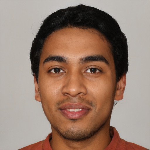 Joyful latino young-adult male with short  black hair and brown eyes