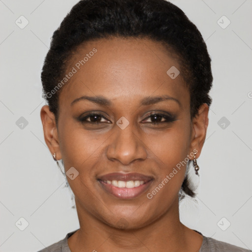 Joyful black young-adult female with short  brown hair and brown eyes