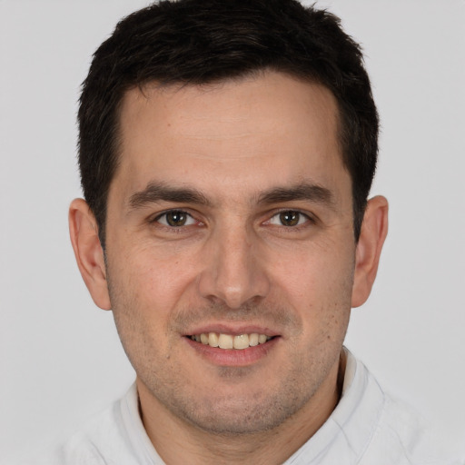 Joyful white young-adult male with short  brown hair and brown eyes