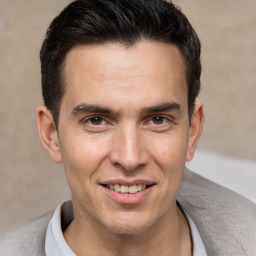 Joyful white adult male with short  brown hair and brown eyes