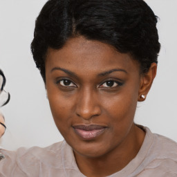 Joyful black young-adult female with short  brown hair and brown eyes