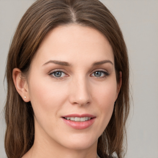 Joyful white young-adult female with medium  brown hair and grey eyes