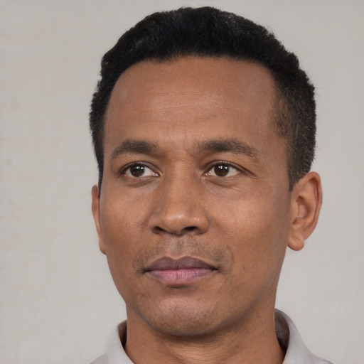 Neutral latino adult male with short  black hair and brown eyes