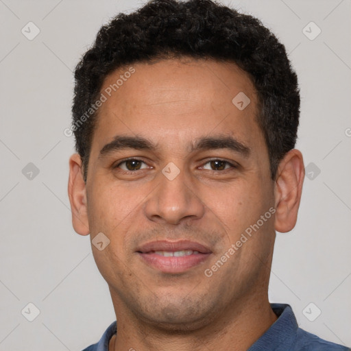 Joyful latino young-adult male with short  brown hair and brown eyes