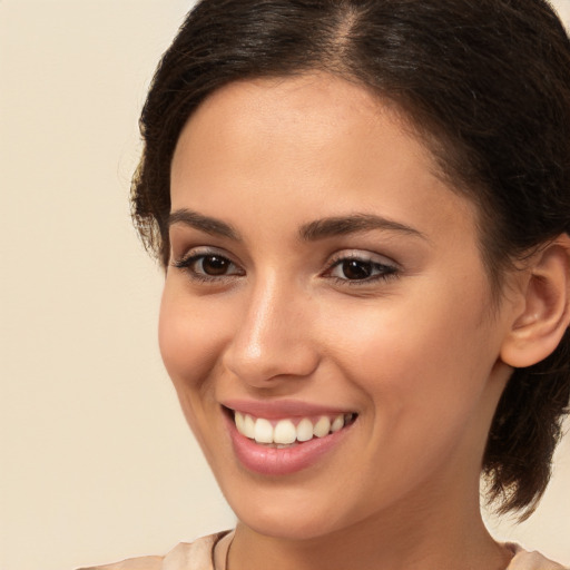 Joyful white young-adult female with medium  brown hair and brown eyes