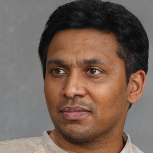 Neutral black adult male with short  black hair and brown eyes