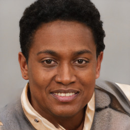 Joyful black adult male with short  brown hair and brown eyes