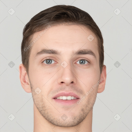 Joyful white young-adult male with short  brown hair and grey eyes