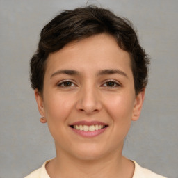 Joyful white young-adult female with short  brown hair and brown eyes