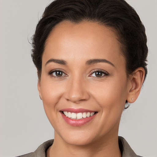 Joyful white young-adult female with short  brown hair and brown eyes