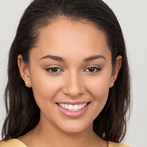 Joyful white young-adult female with long  brown hair and brown eyes