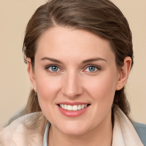 Joyful white young-adult female with medium  brown hair and blue eyes