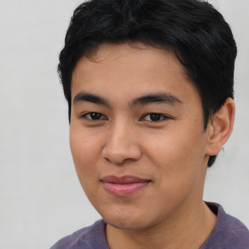 Joyful asian young-adult male with short  brown hair and brown eyes