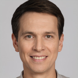 Joyful white adult male with short  brown hair and grey eyes