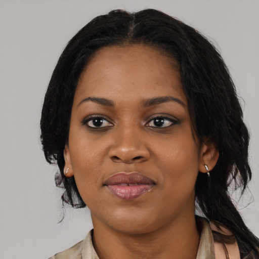 Joyful black young-adult female with medium  black hair and brown eyes