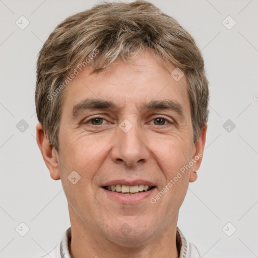 Joyful white adult male with short  brown hair and grey eyes