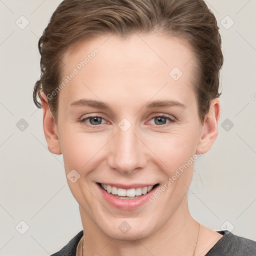 Joyful white young-adult female with short  brown hair and grey eyes