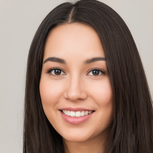 Joyful white young-adult female with long  black hair and brown eyes