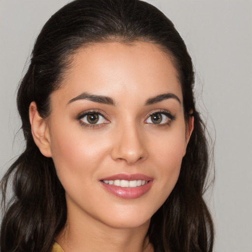 Joyful white young-adult female with long  brown hair and brown eyes