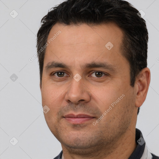 Joyful white adult male with short  brown hair and brown eyes