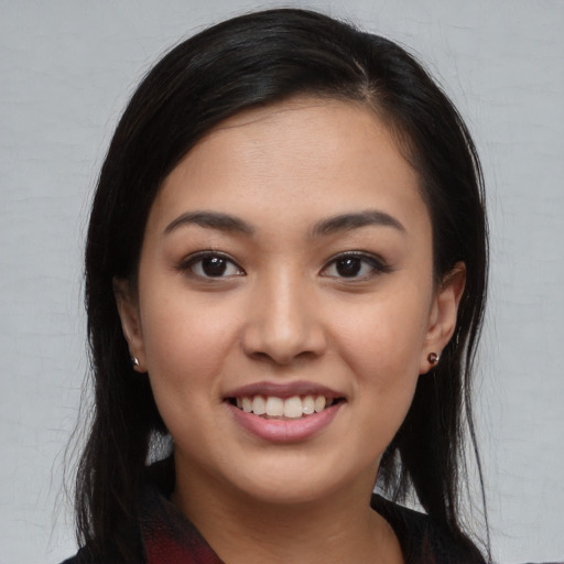 Joyful asian young-adult female with long  brown hair and brown eyes