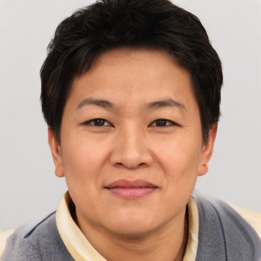 Joyful asian adult female with short  brown hair and brown eyes