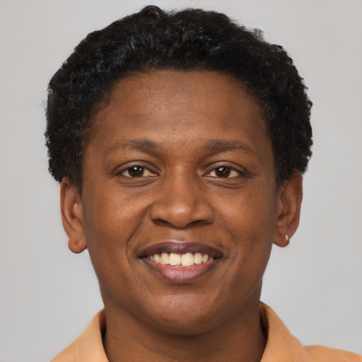 Joyful black young-adult female with short  brown hair and brown eyes