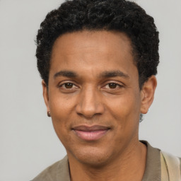 Joyful black young-adult male with short  black hair and brown eyes