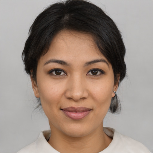 Joyful latino young-adult female with medium  brown hair and brown eyes